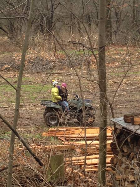 daughters on wheeler near rough cut pile