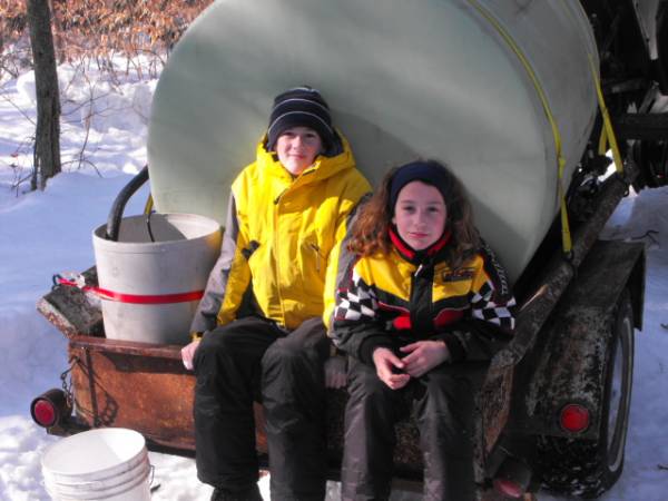 grandkids hitching a ride on the sap wagon