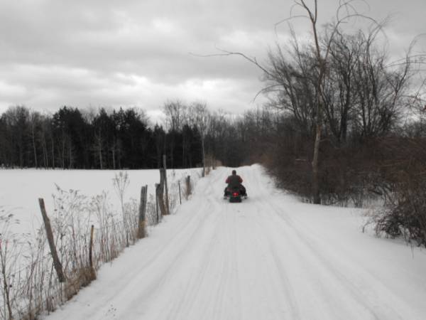 Ron riding up the road to the sugarbush on his trusty old Artc cat El Tigre